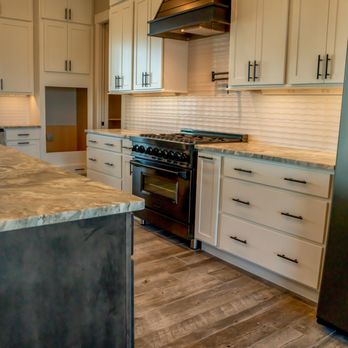 Metro Reconstruction Services - a kitchen with white cabinets and stainless steel appliances - General Contractors Near Me - Boulder, Colorado