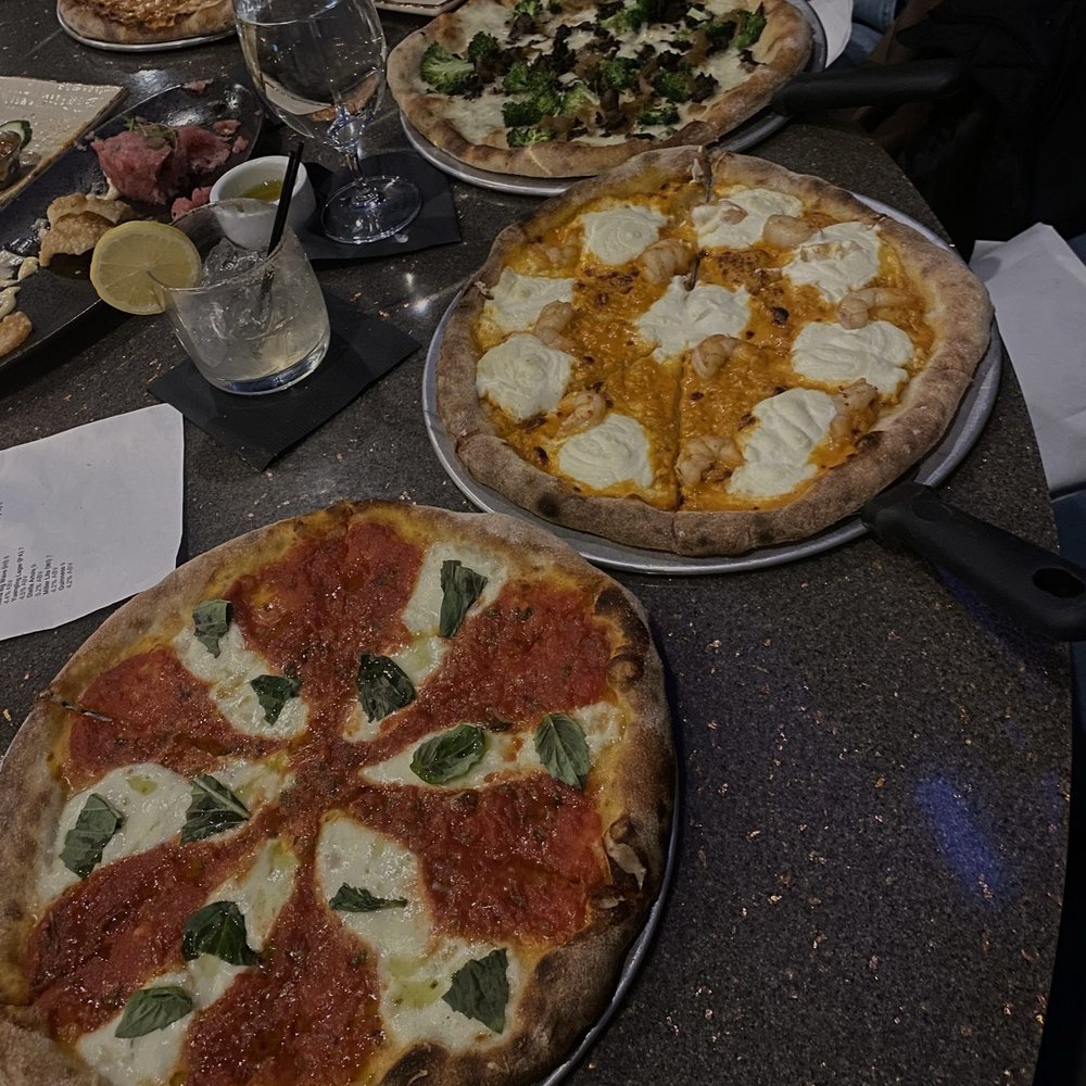 SURV Restaurant - margarita pizza, shrimp Diablo pizza, veggie pizza, and cheese pizza  (from left to right) - Wine Bars Near Me - Easton, Pennsylvania