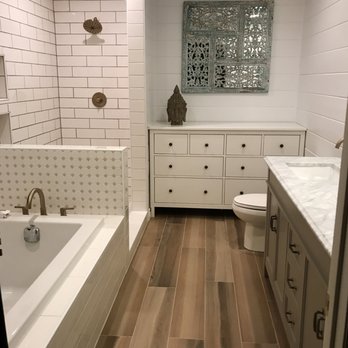 CMF Contracting - a bathroom with white tile and wood floors - General Contractors Near Me CMF Contracting - a bathroom with white tile and wood floors - General Contractors Near Me