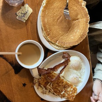 Old West Cafe - Bronco!! Pancake (look at size compared to fork) hash browns, eggs, and bacon!! - Breakfast & Brunch Near Me - Grapevine, Texas Old West Cafe - Bronco!! Pancake (look at size compared to fork) hash browns, eggs, and bacon!! - Breakfast & Brunch Near Me - Grapevine, Texas