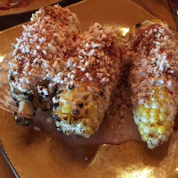Bourbon & Baker - Corn on the cob: mayo-sour cream, smoked paprika rub, cotija cheese, heirloom tomato salsa - Tapas/Small Plates Near Me - Manhattan, Kansas Bourbon & Baker - Corn on the cob: mayo-sour cream, smoked paprika rub, cotija cheese, heirloom tomato salsa - Tapas/Small Plates Near Me - Manhattan, Kansas
