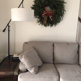 a wreath on a wall above a couch a wreath on a wall above a couch