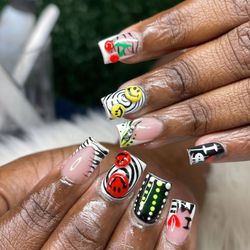Prettii Beauty Boutique - Playful Graphics: Black and white striped tips with smiley faces, cherries, and quirky designs for a funky, retro feel