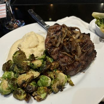 Dantanna's - 14oz Ribeye, roasted garlic mashed potatoes, Brussel Sprouts - Sports Bars Near Me - Atlanta, Georgia Dantanna's - 14oz Ribeye, roasted garlic mashed potatoes, Brussel Sprouts - Sports Bars Near Me - Atlanta, Georgia