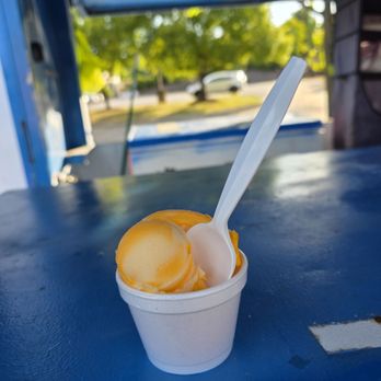 Delicia's Gourmet Ice - My small size Mango Gourmet Ice sitting on the counter of the little blue box trailer. - Food Trucks Near Me - Roanoke, Virginia