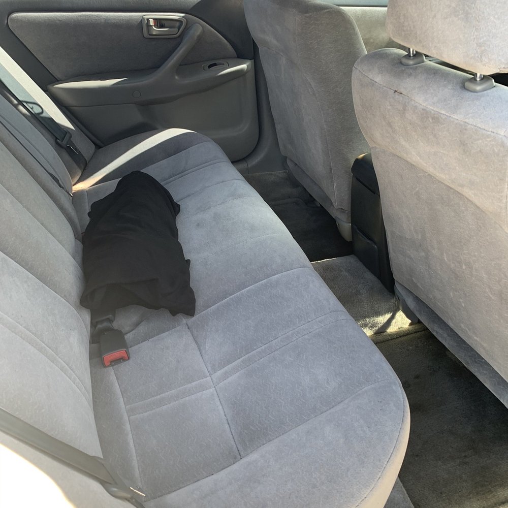 Back seat of my car where my neck pillow with dog hair or whatever...