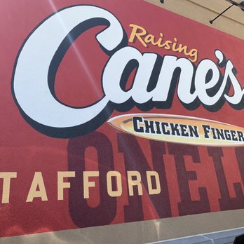 Raising Cane’s - Stafford - a sign for raising cane's chicken fingers - Chicken Shop Near Me - Stafford, Texas
