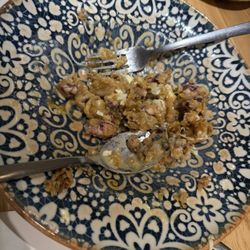 Triana - Puntillitas de Isla Cristina con Parmentier de Trufa y Huevo Frito mixing all the truffle oil and egg flavor.