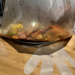 The Juicy Seafood - Seafood boil bag with snow crab legs, shrimp, sausage, corns, and eggs