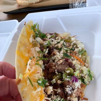 East Texas Rust BBQ - Sneek-peak at the insides of the Thursday brisket taco. Yum! And a Chopped Beef Sandwich is lurking in the background. - Barbeque Near Me - Gilmer, Texas