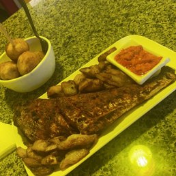 Grilled fish with plantain and puff puff on top Grilled fish with plantain and puff puff on top