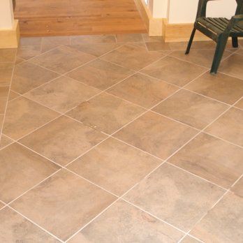 The Floor Works - a tiled hallway with a chair - Flooring Near Me - Bethlehem, New Hampshire The Floor Works - a tiled hallway with a chair - Flooring Near Me - Bethlehem, New Hampshire