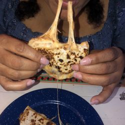 Takos al Pastor - My mom enjoying a VERY cheesy chicken quesadilla! I was envious
