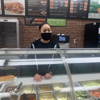 Subway - a woman wearing a face mask behind a deli counter - Sandwiches Near Me - Newark, New York Subway - a woman wearing a face mask behind a deli counter - Sandwiches Near Me - Newark, New York