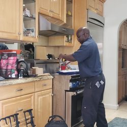 Donavan's Appliance Repair - Donovan working hard to get my stove firing up again.