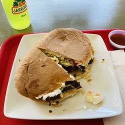 Maria's Kitchen - Steak torta, lime Jarrito, and hot sauce..
