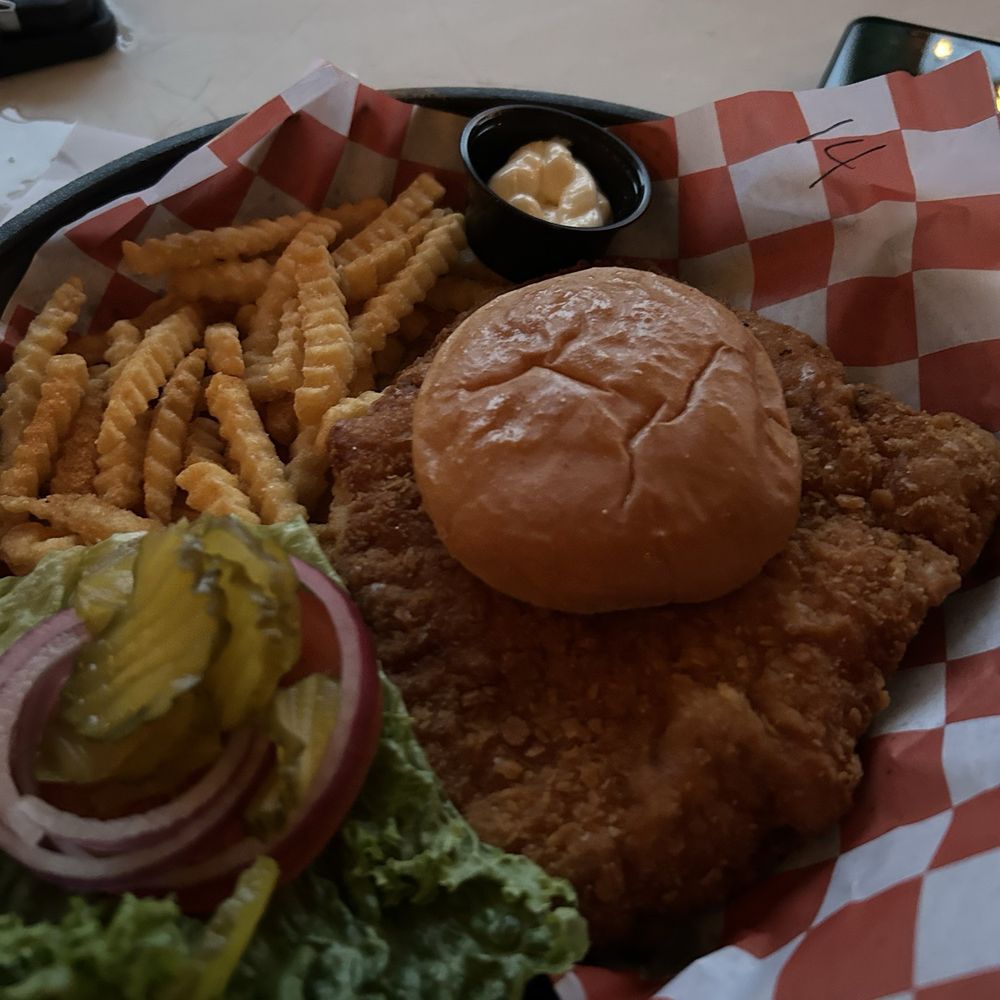 Pork tenderloin sandwich with seasoned fries Pork tenderloin sandwich with seasoned fries
