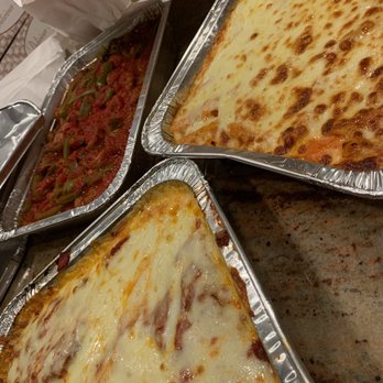 Pizza D'Amore - three pans of pizza on a table - Italian Near Me - Rockaway Park, New York Pizza D'Amore - three pans of pizza on a table - Italian Near Me - Rockaway Park, New York