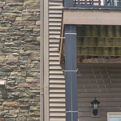 Eden Square Apartments - pillar facing held on with white zip ties