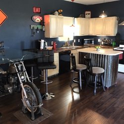 Tailgate Ranch - The dining room and kitchen, complete with a freaking motorcycle! So awesome!