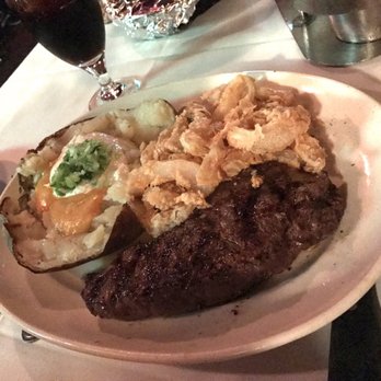 Clearman's Steak 'N Stein - Onion rings, NY strip steak and potato with "cheese" sauce, sour cream and "chives." Steak was equally delectable. - Steakhouses Near Me - Pico Rivera, California