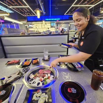KPOT Korean BBQ & Hot Pot - My waitress cooking my Korean BBQ on the round table grill. - Barbeque Near Me - Roanoke, Virginia KPOT Korean BBQ & Hot Pot - My waitress cooking my Korean BBQ on the round table grill. - Barbeque Near Me - Roanoke, Virginia