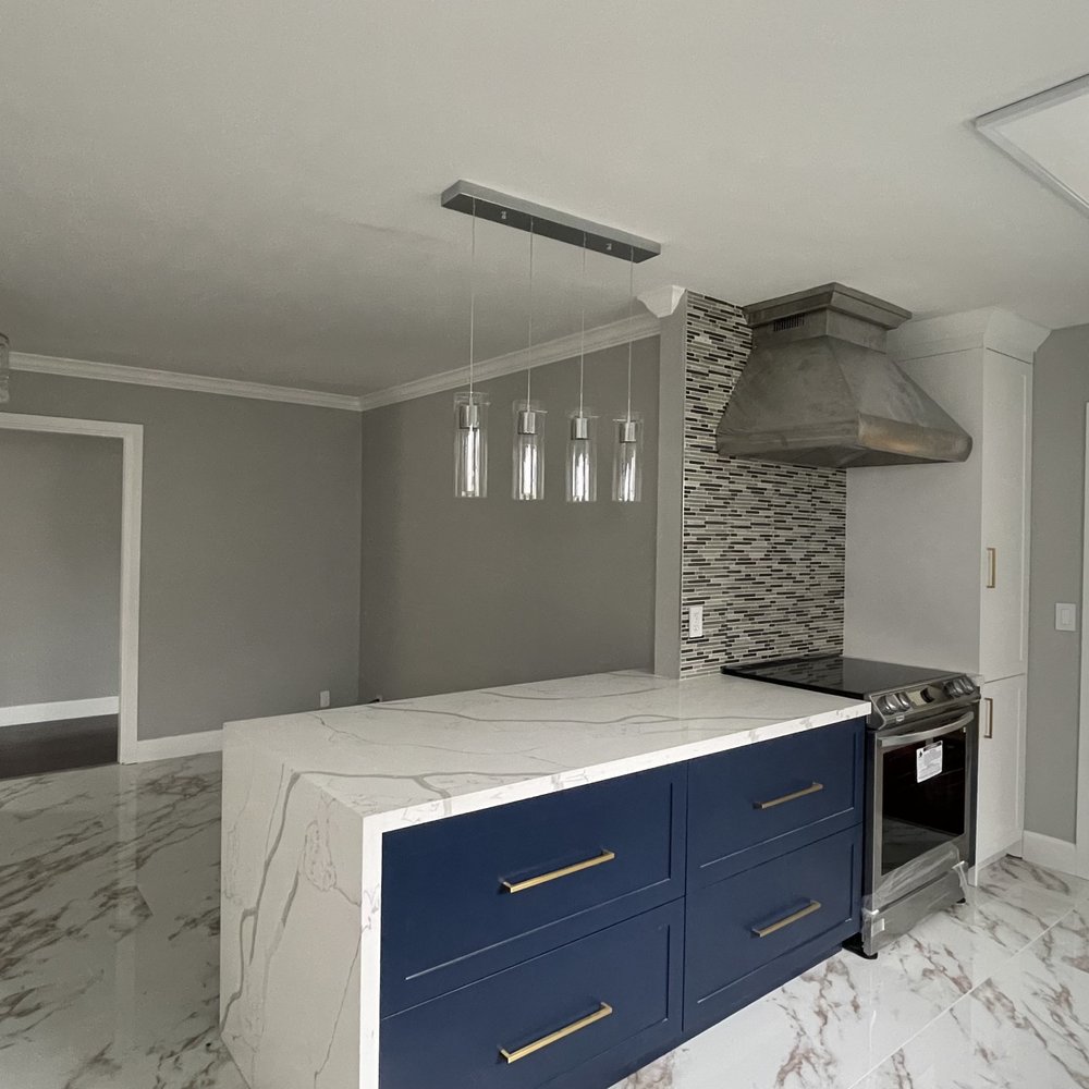 Inkas Construction - a kitchen with marble countertops - General Contractors Near Me