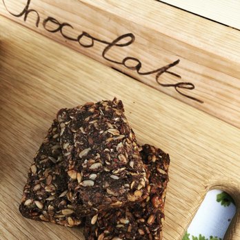 OGIA - a stack of chocolate bars on a cutting board - Bakeries Near Me