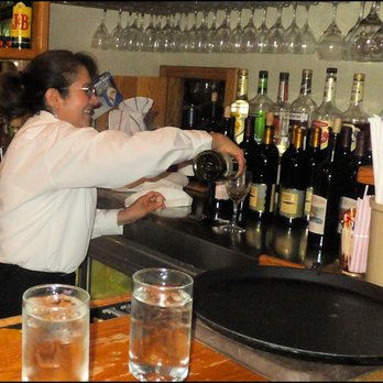 Cavalier Coastal Kitchen - Our friendly hostess, Nora, pours Sharlene's glass of wine.  Cavalier Restaurant features a full-service bar. - American Near Me - San Simeon, California