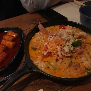 Take31 - Creamy kimchi stew (right) and complimentary ddukbokki (left) - Korean Near Me - New York, New York Take31 - Creamy kimchi stew (right) and complimentary ddukbokki (left) - Korean Near Me - New York, New York