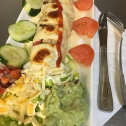 Our new Burrito ! Steak,peppers,mushrooms,served with fresh guacamole,salad and queso.