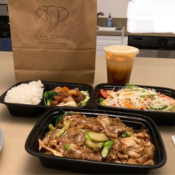 Siam Station - Top left is the White Rice with Crispy Pork & veggies. Next to it is the Papaya Pok Pok. Bottom is the Pad See Ew. Drink is Thai ice tea. - Thai Near Me - Irvine, California Siam Station - Top left is the White Rice with Crispy Pork & veggies. Next to it is the Papaya Pok Pok. Bottom is the Pad See Ew. Drink is Thai ice tea. - Thai Near Me - Irvine, California