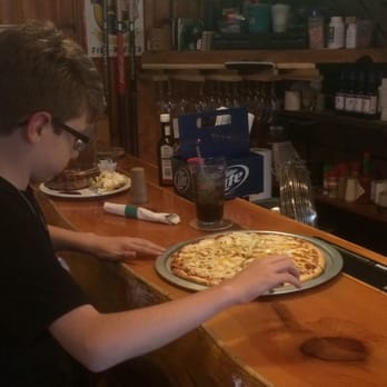Jake's Bar & Grill - a young man preparing a pizza - New American Near Me - Three Lakes, Wisconsin