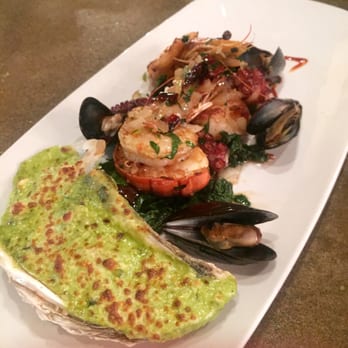 Hugo's - Mariscos al Ajillo | sautéed lobster, shrimp, scallops and octopus served with arroz blanco - Mexican Near Me - Houston, Texas