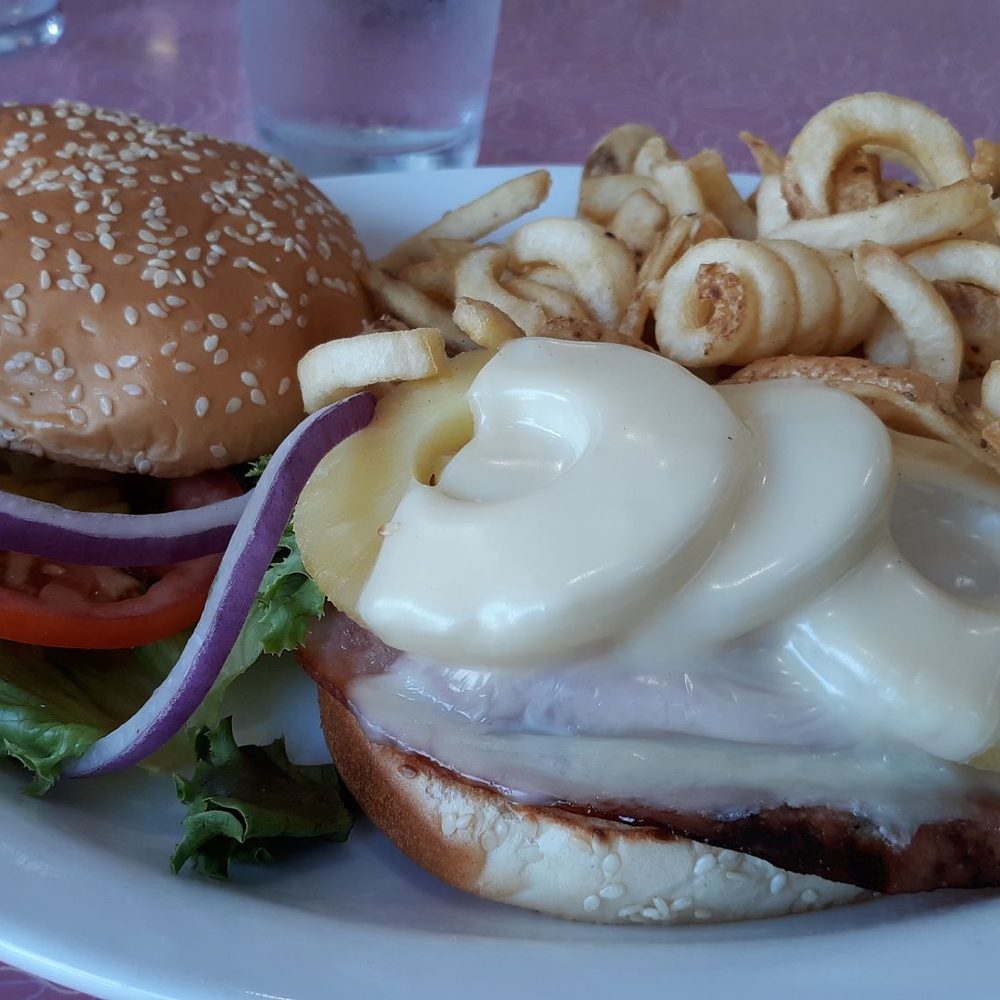 Teriyaki chicken sandwich with curly fries. Teriyaki chicken sandwich with curly fries.