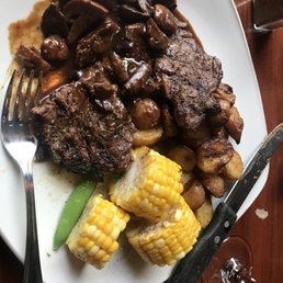 a plate of steak, potatoes, and corn a plate of steak, potatoes, and corn