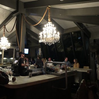 Table 23 - Chandelier over the bar. Cute idea!! - New American Near Me - Tallahassee, Florida Table 23 - Chandelier over the bar. Cute idea!! - New American Near Me - Tallahassee, Florida