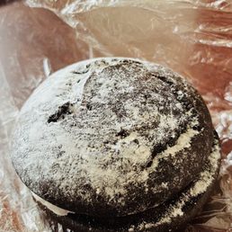a chocolate cake covered in powdered sugar a chocolate cake covered in powdered sugar