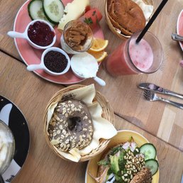 The "lazy breakfast" plate, an Oathie bagel, and a chicken pesto and pine nut bagel in a Everything Sourdough.