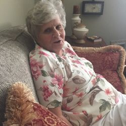 The Village at Eastgate - Sitting on her sofa in her apartment.