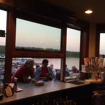 Boathouse Grille - This is the view from the bar area, overlooking a huge deck dining area, a good portion of the deck is covered! - New American Near Me - New Baltimore, New York Boathouse Grille - This is the view from the bar area, overlooking a huge deck dining area, a good portion of the deck is covered! - New American Near Me - New Baltimore, New York