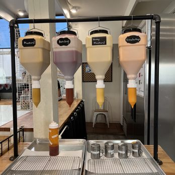 Seoul Hotdog - Self serve sauce. I got honey mustard + siracha Mayo - Hot Dogs Near Me - Berkeley, California
