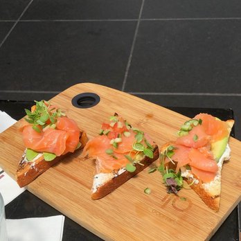 IO Godfrey - Avocado toast; which consists of sliced brioche, smoked salmon, cucumber, tomato relish & herbed cream cheese. - Cocktail Bars Near Me - Chicago, Illinois