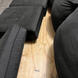 Wood board in seat of sofa instead of upholstery.