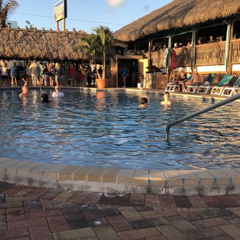 Sunset Grille - a pool with people in it - Food Near Me