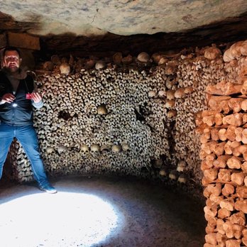 Les Catacombes de Paris - Bones stacked to the ceiling. - Local Flavor Near Me - Paris, 75 Les Catacombes de Paris - Bones stacked to the ceiling. - Local Flavor Near Me - Paris, 75