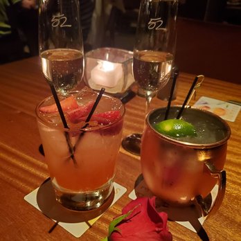 Seasons 52 - Rose & champagne from the manager to celebrate our anniversary. Summer seasonal cocktails. Strawberry infused vodka and peach mule. - New American Near Me - Lone Tree, Colorado