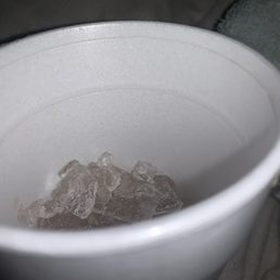 a white cup with ice in it