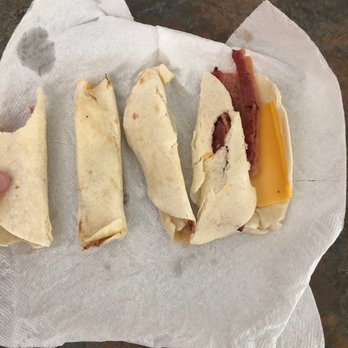 Dunkin' - a person's hand holding a sandwich - Donuts Near Me - Brooklyn, Connecticut Dunkin' - a person's hand holding a sandwich - Donuts Near Me - Brooklyn, Connecticut