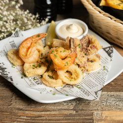 Mali Ston Wine Bar - Calamari Fritti Golden fried calamari and prawns served with lemon and aioli. Fresh, light and perfect for sharing.